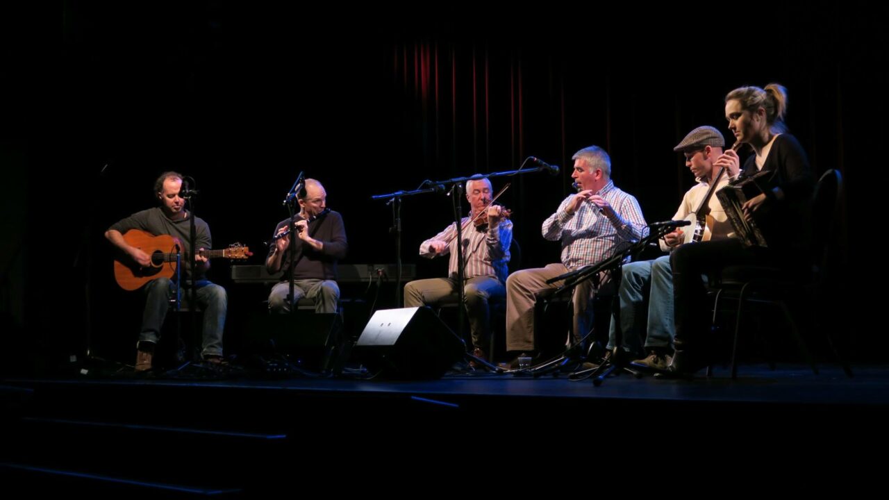 Musicians on stage playing at a traditional Irish music at a concert